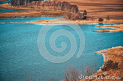 Nature in Norway. Typical scenery from Scandinavia with blue lakes, white ship, trees of birch and red houses Stock Photo