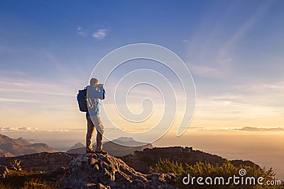 Nature photographer traveler taking photo of beautiful landscape Stock Photo