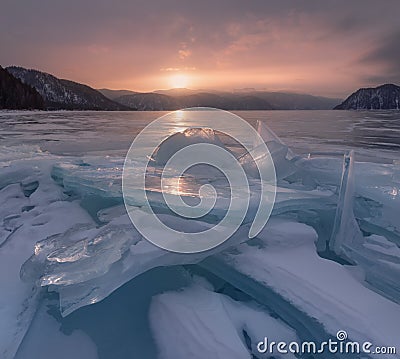 Nature Of Russia, Siberian Landscape: Frozen Blue Ice Of The Teletskoye Lake, Shot At Sunrise. Nature Of Siberia. One Of The Attra Stock Photo