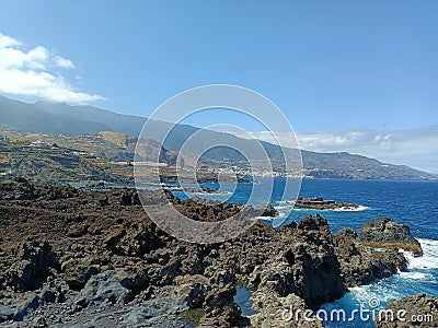 Nature's artistry on display as rugged rocks extend into the vast sea Stock Photo