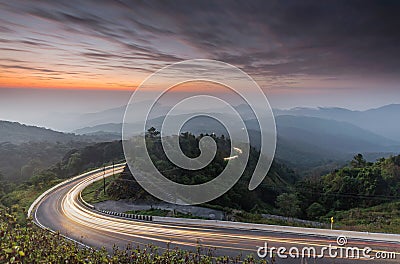 Nature sunrise background amazing curve road and twilight color long exposure view. Popular travel Mountain in Thailand Stock Photo