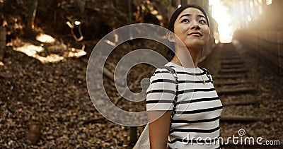 Nature, travel and Japanese woman in park for adventure on holiday, vacation and morning in woods. Thinking, happy and Stock Photo