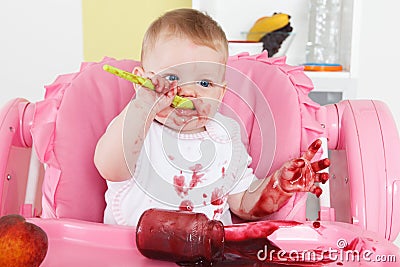 Naughty baby eating alone Stock Photo