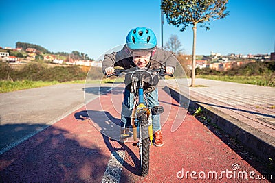 Naughty boy with defiant gesture over his bike Stock Photo