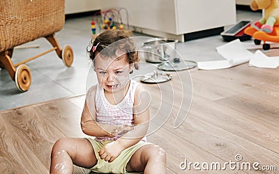 Naughty little child sitting on the floor Stock Photo
