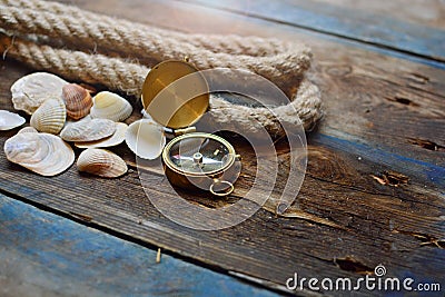 Nautical background. Old deck with rope, compass and shells Stock Photo