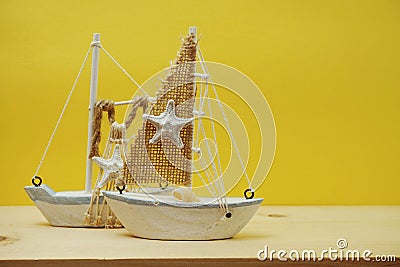 Nautical background with Sailboat Model on yellow background Stock Photo