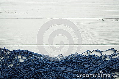 Nautical Blue Fishing net frame with space copy on wooden background Stock Photo