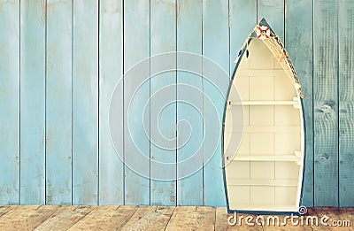 Nautical boat shape shelves on wooden table. product display background, vintage filtered Stock Photo