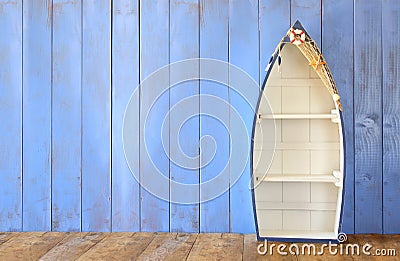 Nautical boat shape shelves on wooden table. product display background, vintage filtered Stock Photo