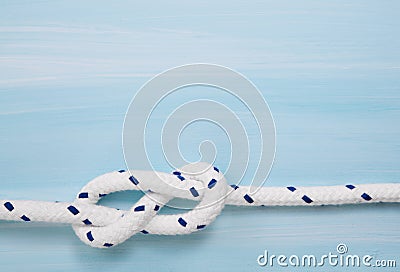 Nautical maritime wooden background in blue color with rope. Stock Photo
