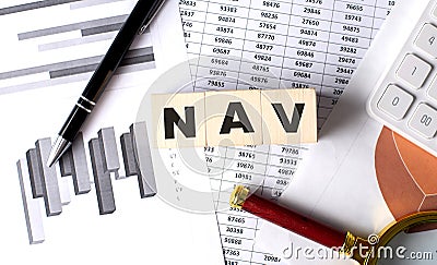 NAV text on wooden block on graph background with pen and magnifier Stock Photo