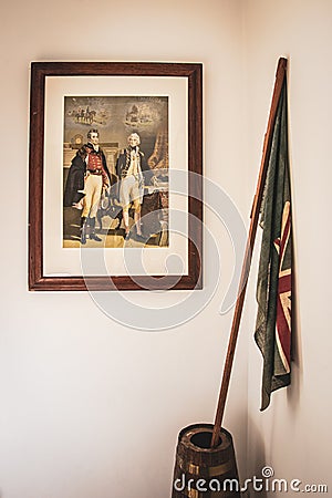 06/06/2020 Portsmouth, Hampshire, UK Naval themed artwork on a wall of a home with an old Ensign naval flag by its side Editorial Stock Photo