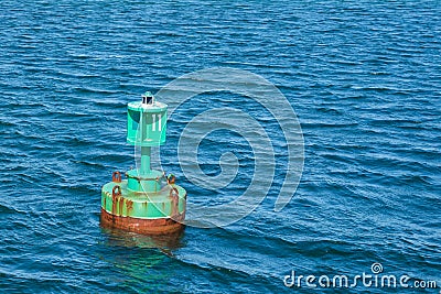 Navigational buoy anchored at the netrance of a harbour Stock Photo