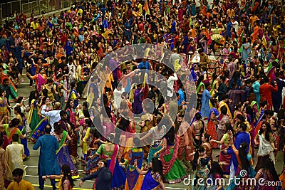 Girls, Man, women are performing garba and dandiya dance wearing traditional Indian folk dress during Navratri festival,Canada Editorial Stock Photo