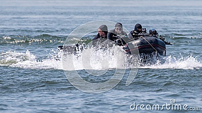 Navy military special force team in action with guns and black diver suites Editorial Stock Photo