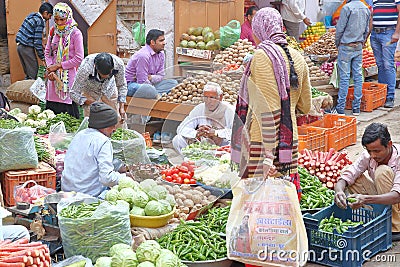 NAWALGARH, RAJASTHAN, INDIA - DECEMBER 28, 2017: Colorful street scene at the vegetable market with food stalls Editorial Stock Photo