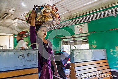 NAWNGHKIO, MYANMAR - NOVEMBER 30, 2016: Snack vendor in the train in Nawnghkio Naunghkio, Naungcho or Nawngcho near Gokteik Editorial Stock Photo