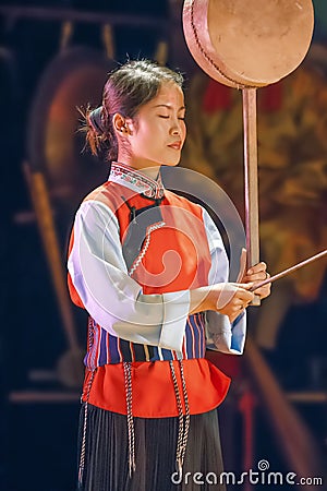A Naxi woman performs in a theater, Lijiang, China Editorial Stock Photo