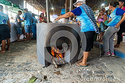 People making food on the wood stove at the Caxixis fair in Nazare, Bahia Editorial Stock Photo
