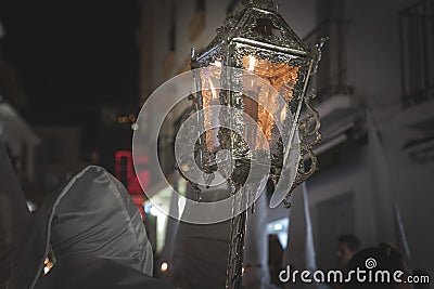 Nazarene in a procession at the holy week holding a candle Stock Photo
