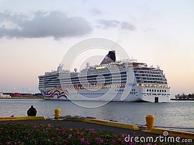 NCL Cruiseship leaves Honolulu Harbor at Dusk Editorial Stock Photo