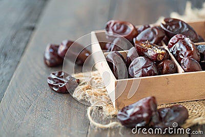 Dried fruits date palm fruits . fresh dates whole and half on wood background Stock Photo