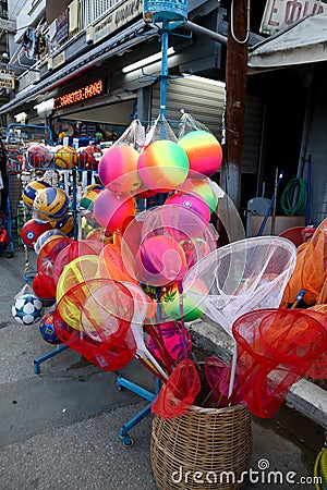 Colorful fishing net, beach balls and other beach toys for kids Editorial Stock Photo