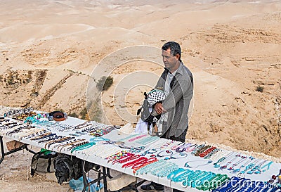Bedouin - the seller of handmade decorative ornaments and memorable souvenirs on the viewing platform near Mitzpe Yeriho in Israel Editorial Stock Photo