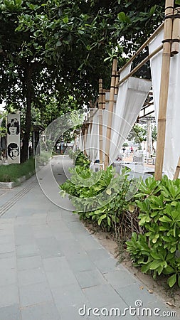 neat stone path. beautiful little street. streets in the middle of parks and gardens. cracked cement roads. Stock Photo