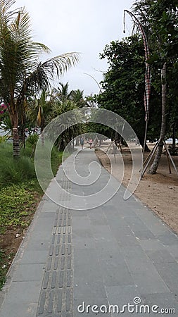 neat stone path. beautiful little street. streets in the middle of parks and gardens. cracked cement roads. Stock Photo