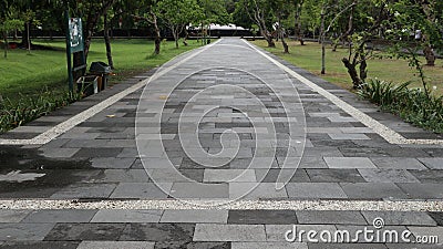 neat stone path. beautiful little street. streets in the middle of parks and gardens. cracked cement roads. Stock Photo