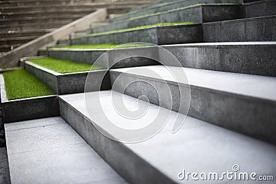 Neat and tidy grey stair steps made of stone and granite tiles with a curb. Stock Photo