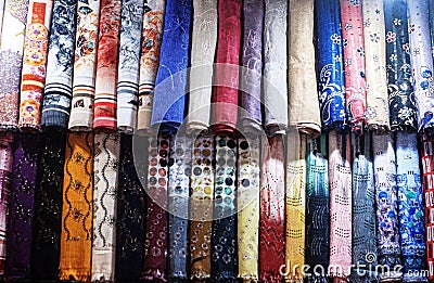 A neatly arranged display of colorful, patterned fabrics. Stock Photo