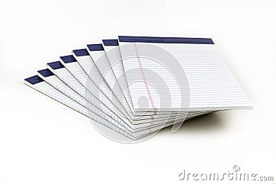 A neatly arranged stack of white, ruled notepads with blue binding Stock Photo