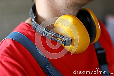 On neck builder hang yellow soundproof headphones Stock Photo