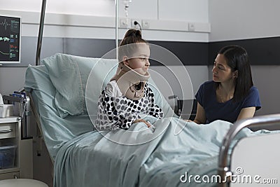 Neck injured hospitalized girl with cervical collar resting in hospital pediatric ward Stock Photo