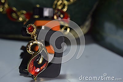 Necklace and earrings are gold and painted in red. To add beauty Designed Charming, Editorial Stock Photo