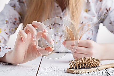 Need more vitamins, Woman with hair problems, lost hair on comb Stock Photo