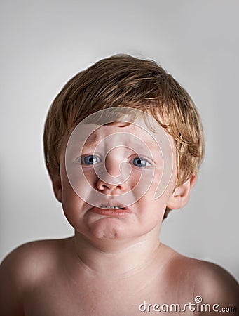 In need of some comforting. Upset red-headed toddler getting ready to cry. Stock Photo