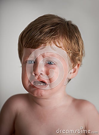 In need of some comforting. Upset red-headed toddler getting ready to cry. Stock Photo