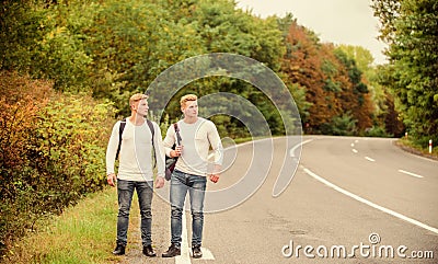 Need to go. wanderlust concept. Hiking with friends is cool. gone to find themselves. Travel hitch-hiking. twins walking Stock Photo