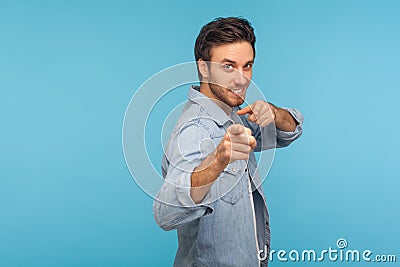 We need you! Portrait of cheerful happy man in worker denim shirt noticing and pointing finger to camera Stock Photo