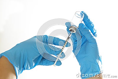 A needle and a vaccination bottle in the doctor`s hand Stock Photo