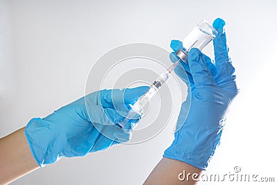 A needle and a vaccination bottle in the doctor`s hand Stock Photo