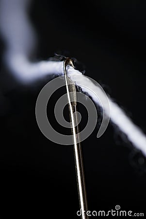 Needle and white thread Stock Photo