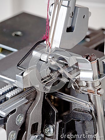 Needles with thread in overstitching machine Stock Photo