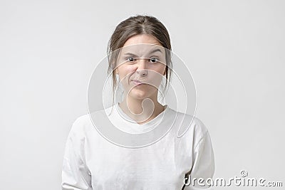 Negative human emotions and feelings. Grumpy young, frowning eyebrows, her look and grimace expressing anger Stock Photo