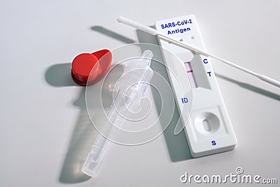 Negative result on a rapid antigen self test kit for covid-19 diagnostic with nasal swabs, tube and detection device, light gray Stock Photo