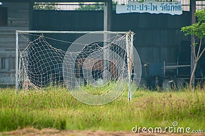 Neglected empty soccer football net on field , unused, dilapidated , Old goal Stock Photo